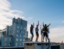 Group of people jumping on a building during day time